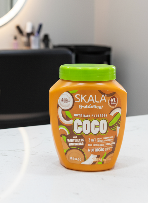 Skala Coco product jar with green lid on a beige background