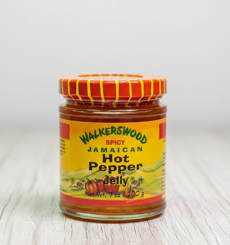 Jar of Walkerswood Spicy Jamaican Hot Pepper Jelly with a red and yellow striped lid on a white background.