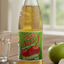 A bottle of Solo J Apple Juice with a green and red label, clear liquid content, and a cap on top.