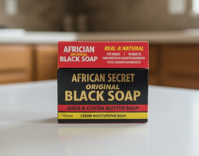 Two boxes of African Secret Black Soap on a white surface with a blurred background.