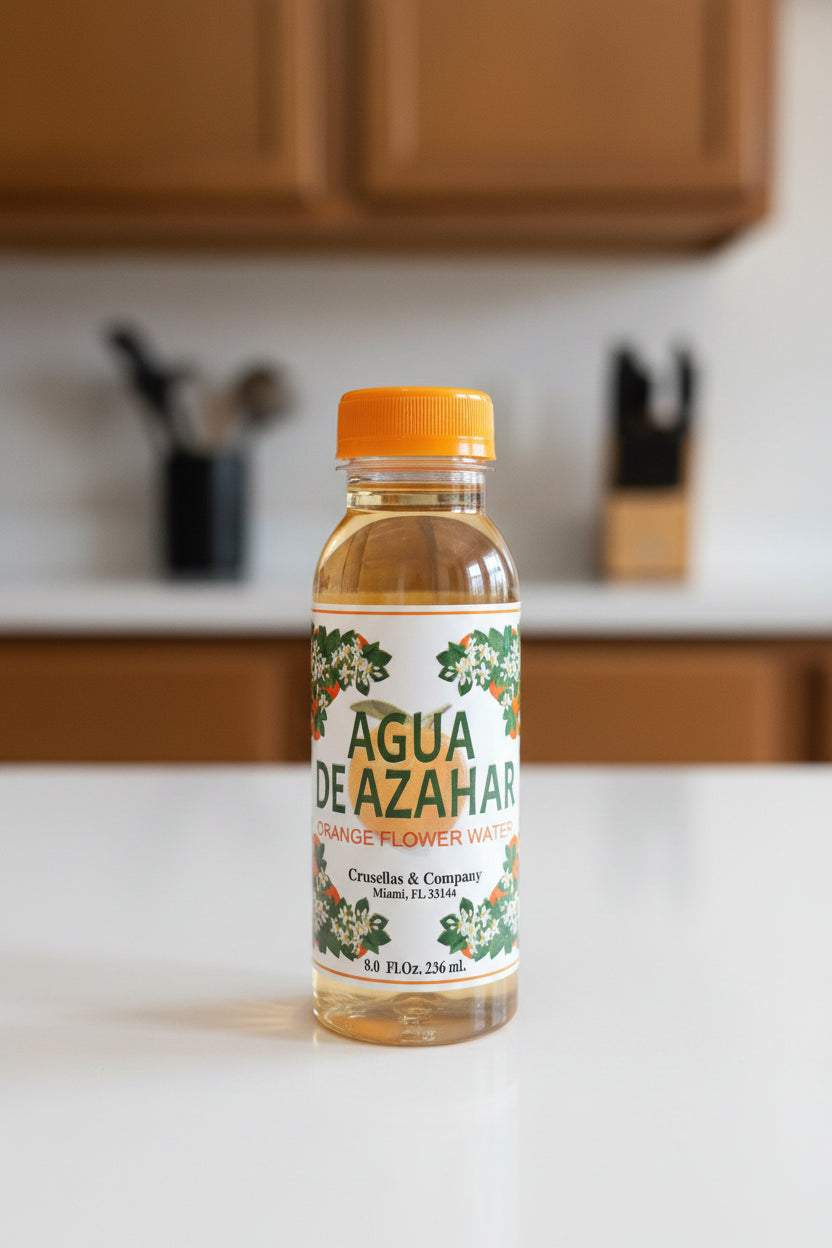 Bottles of Agua de Azahar on a shelf with colorful packaging.