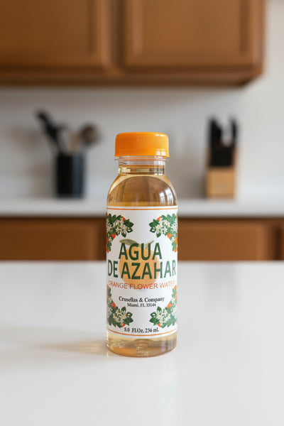 Bottles of Agua de Azahar on a shelf with colorful packaging.
