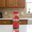 Bottles of 'Aqua de Rosa' on a shelf with a price tag.