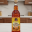 Bottle of Kola Champagne syrup with a visible brand logo on a white background