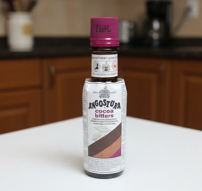Bottle of Angostura Cocoa Bitters on a dark surface