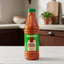 A 750ml plastic bottle of Bertie's Original Pepper Sauce, featuring a green cap and a green label with a red pepper illustration, filled with orange-red sauce.