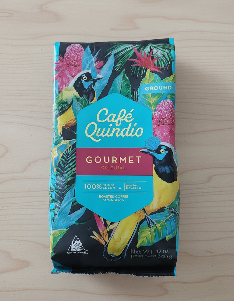 Café Quindio gourmet coffee package with colorful design on a dark background