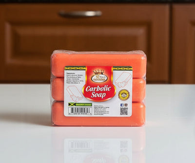 Pack of carbolic soap held in a hand with a blurred background
