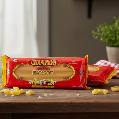 Champion Macaroni package on a wooden surface with scattered pasta pieces.