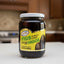 Jar of figs in heavy syrup with a yellow label on a white background