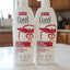 Two bottles of Curel Ultra Healing lotion on a shelf with a price tag.
