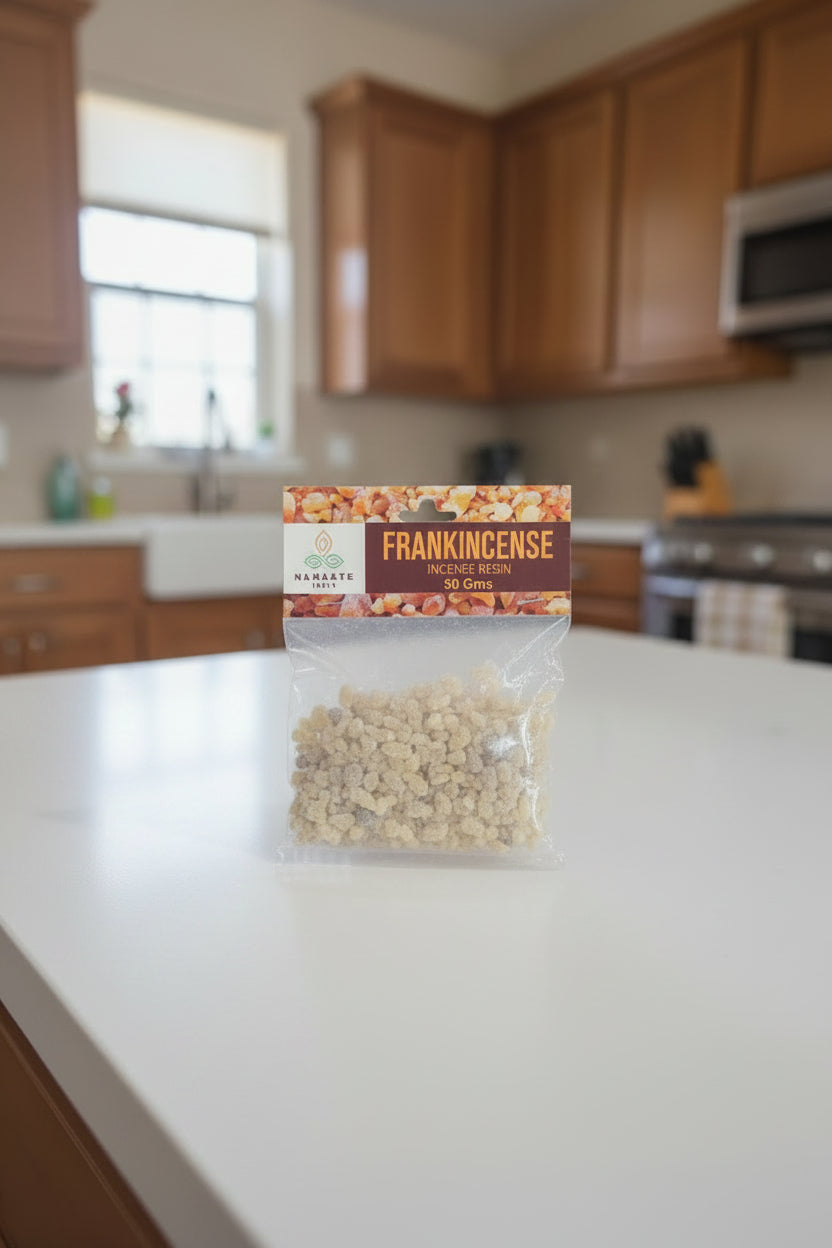 Packaged frankincense resin held by a hand with a blurred background
