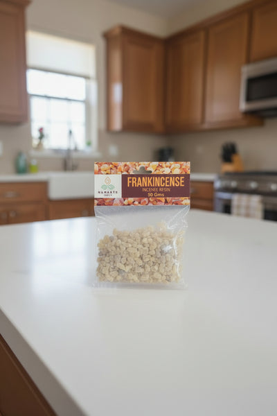 Packaged frankincense resin held by a hand with a blurred background