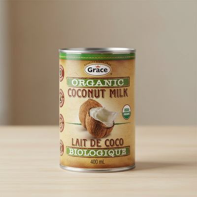 Can of Grace Organic Coconut Milk with coconuts on a beige background