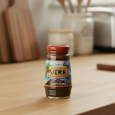 Four bottles of Grace Jamaican Jerk Seasoning on a white background