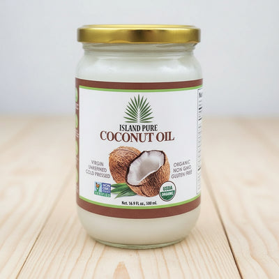 Jar of Island Pure Coconut Oil with a gold lid on a white background