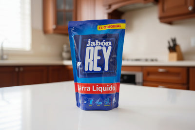 Jabon Rey soap package on a desk with a computer in the background