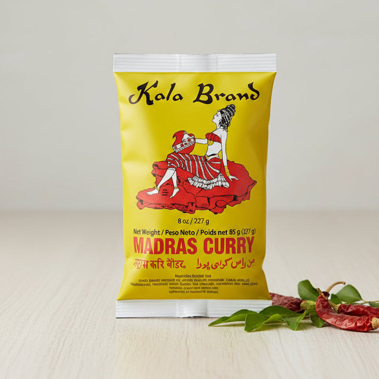 Kola Brand Madras Curry packet with a yellow background