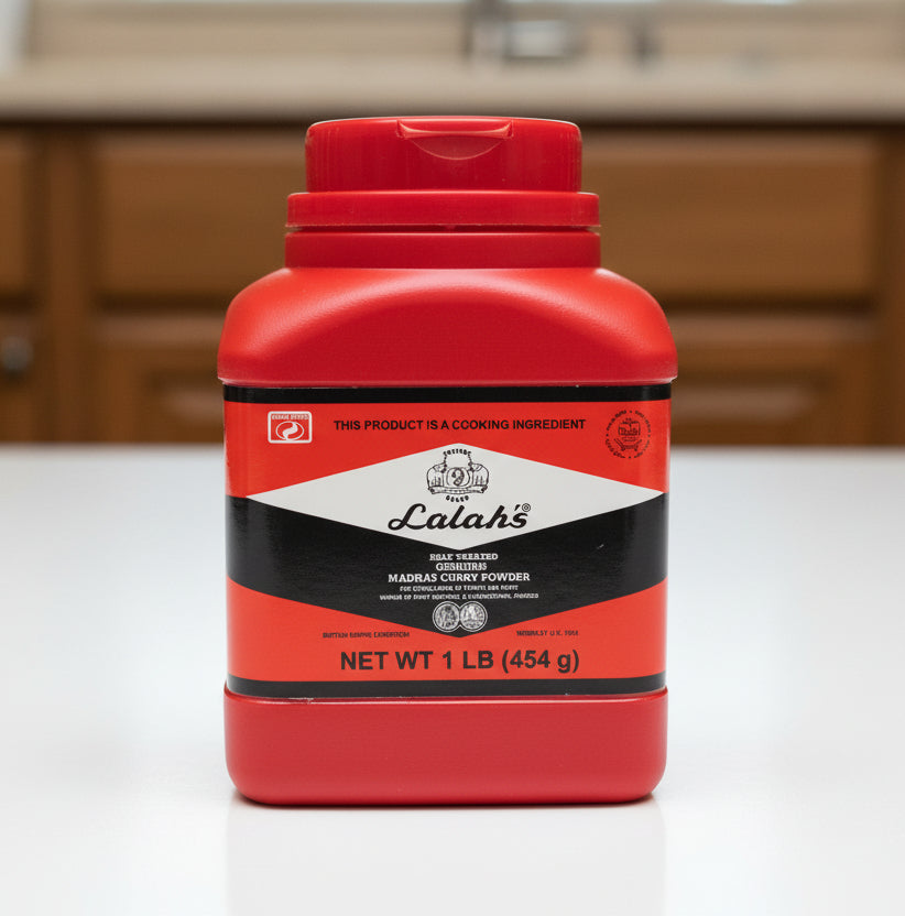Red container of Lalah's Madras Curry Powder on a dark background