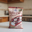 Package of Coffee Coco with red and white design on a gray floor.