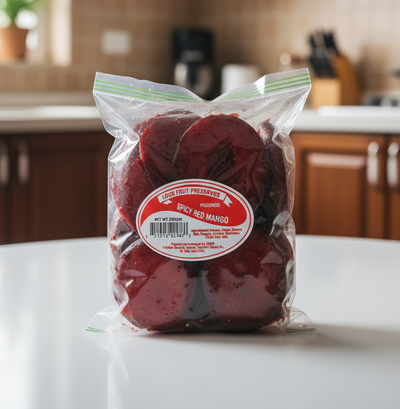 Packaged spicy red mangoes with a visible label on a white background