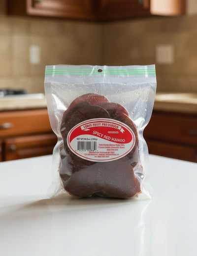 A clear plastic bag of Louis Fruit Preserves Spicy Red Mango dried fruit, showing the reddish-brown slices inside with a prominent red and white label.