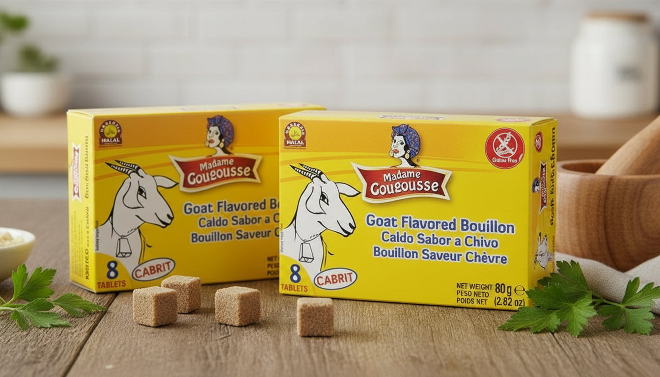 Box of Madame Goussousse Goat Flavored Bouillon on a wooden surface with herbs and a bowl of ingredients.