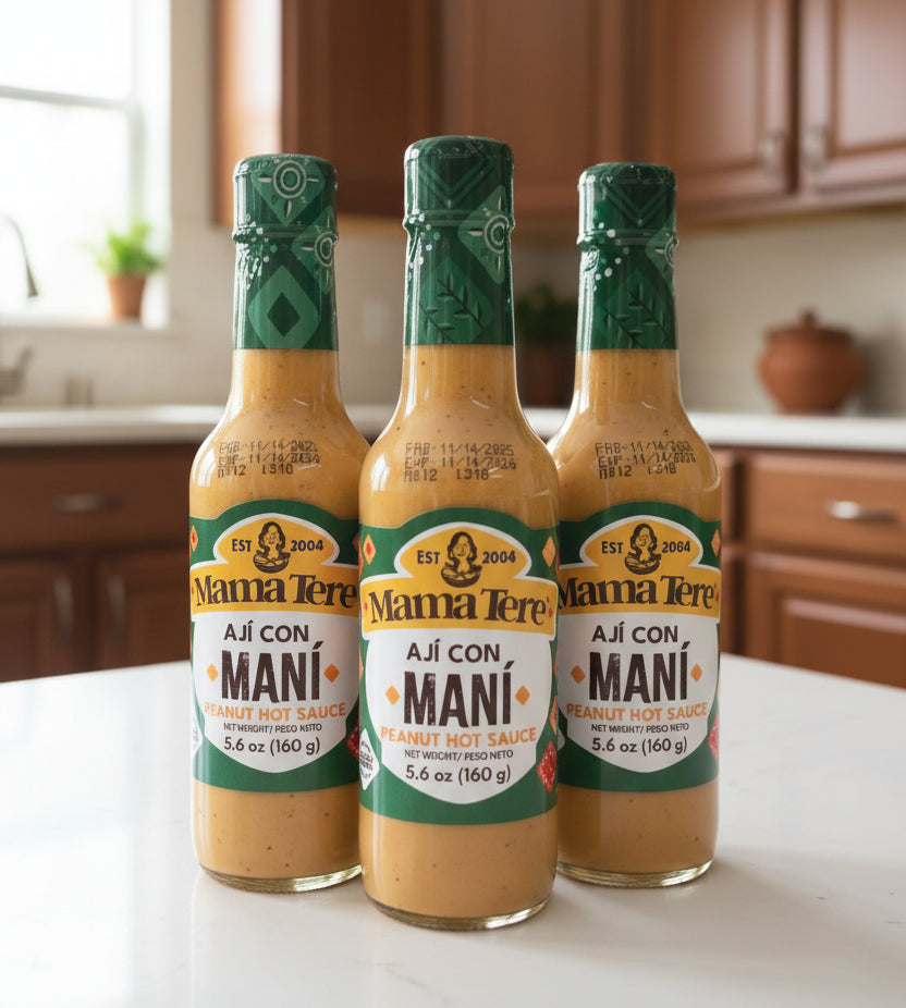 Three bottles of Mama Tere Aji con Mani hot sauce on a shelf with a price tag.