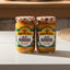 Two jars of Mama Tere Aji Manaba hot sauce on a store shelf with a price tag.