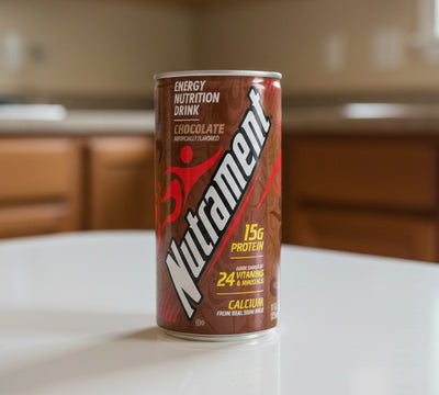 Nutrament energy nutrition drink can in chocolate flavor with 15g protein and 24 vitamins/minerals on a white background.