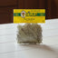 Packaged eucalyptus leaves with a visible brand label on a dark surface.