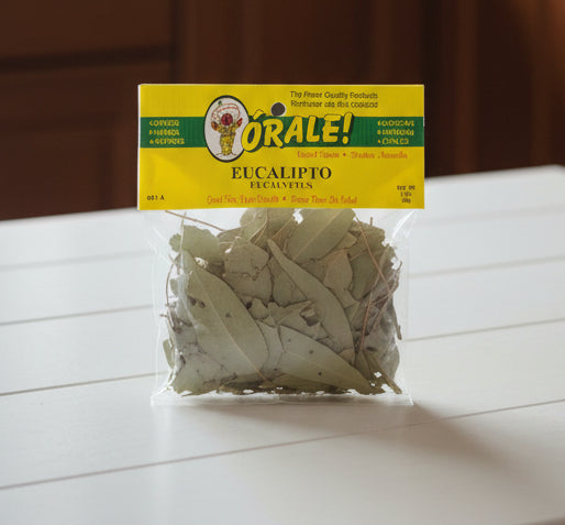 Packaged eucalyptus leaves with a visible brand label on a dark surface.