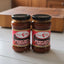 Two jars of Aderezo para Anticuchos on a store shelf with a price tag.