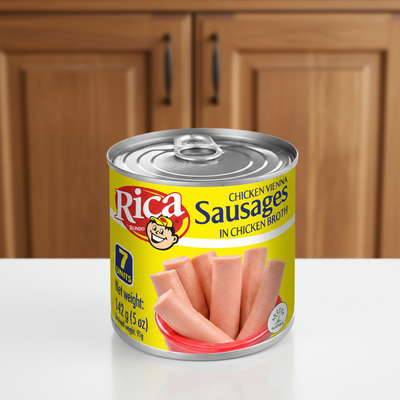 Can of Rica Chicken Vienna Sausages with yellow label and silver lid on a white background