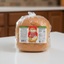 Packaged loaf of Coco Bread with Montezuma branding on a white background