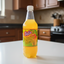 Bottle of Solo Mango soda on a white background