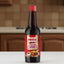 Bottle of Fruco carnes sauce on a white background