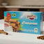 Shavuot Cinnamon tea box with cinnamon sticks and a cup of tea on a blue background