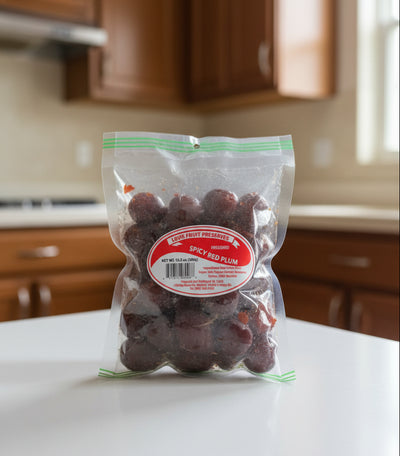 A clear plastic bag of Louis Fruit Preserves Spicy Red Plum, showing the dark red preserved fruit inside with a prominent red and white circular label on the front.