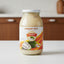 Jar of sourdough pulp with a colorful label on a white background
