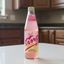 Bottle of Pink Ting on a white background