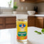 Bottle of Trinidad Bel? coconut oil on a dark surface