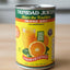 Can of Trinidad Juices orange juice on a shelf with other products.