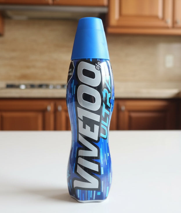 Blue energy drink bottle labeled 'Vivitoo Ultra' on a black surface with various items in the background.