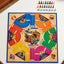 A colorful board game titled 'Juele Linda Eres' set in Colombia, featuring a wooden-textured board with vibrant segments in blue, orange, green, yellow, pink, and red, surrounded by illustrated tokens and game pieces.