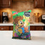 A bag of Frito-Lay Cupiz candy corn snack, featuring a green wrapper with a cartoon lion character and colorful 'Cupiz' branding, placed on a dark gray surface.