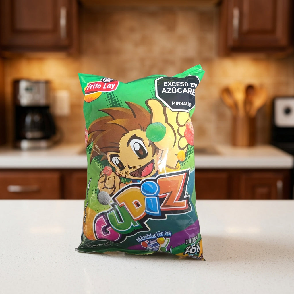 A bag of Frito-Lay Cupiz candy corn snack, featuring a green wrapper with a cartoon lion character and colorful 'Cupiz' branding, placed on a dark gray surface.
