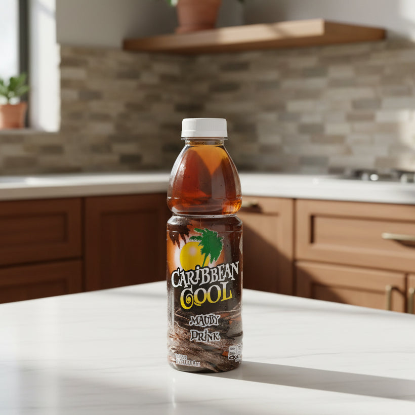 A bottle of Caribbean Cool Mauby Drink on a plain white background. The bottle contains an amber-brown liquid and features a label with a palm tree, a yellow sun, and the brand name 'Caribbean Cool' in stylized lettering.