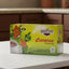 Shavuot Cerasee tea box with a cup of tea and tea leaves on a green background