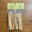 Palo Santo sticks in a clear bag with a green label on a black background